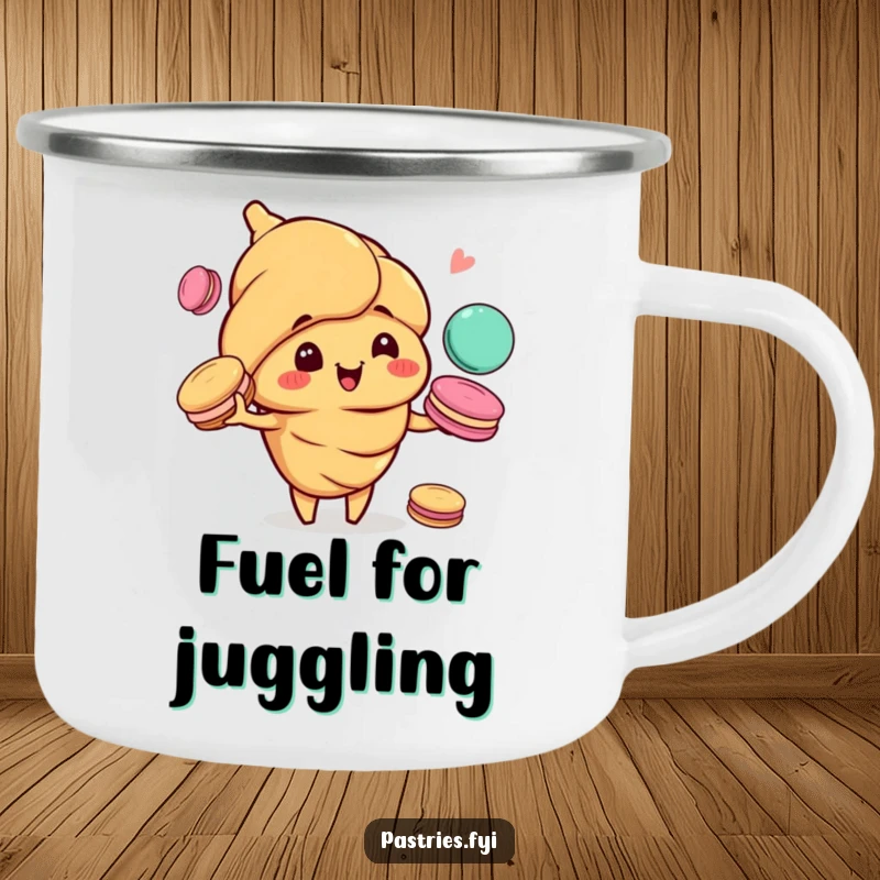 Funny camping mug with a happy croissant character, mischievous grin, juggling colorful macarons, ready for outdoor fun.