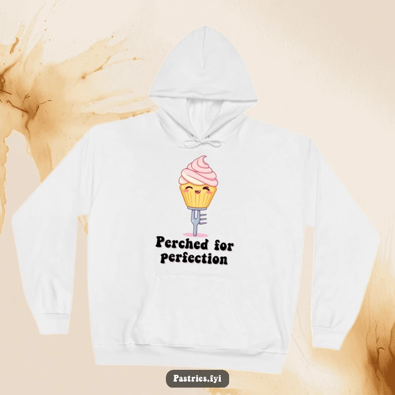 Funny hoodie showcasing a winking cupcake character skillfully balancing on a tiny silver fork, inviting warmth.