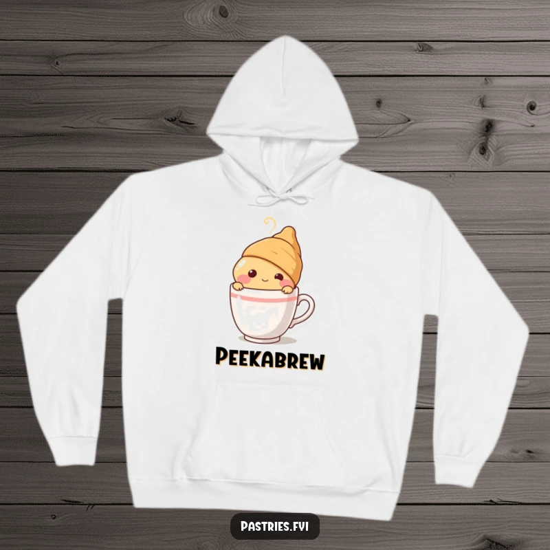 Funny blushing croissant character peeking from behind a steaming coffee cup, designed on a soft, cozy hoodie for ultimate comfort and charm.