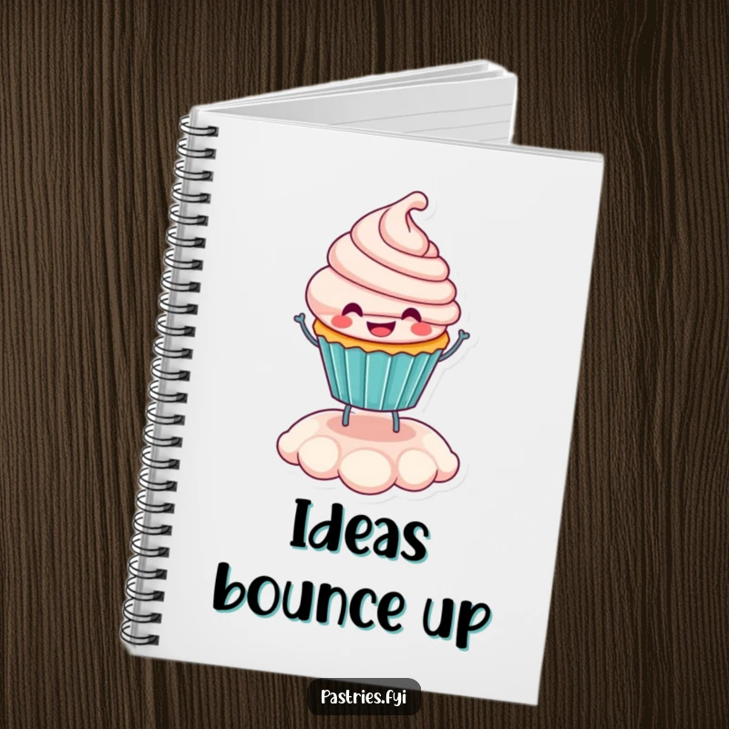 Funny smiling cupcake character bouncing on its frosting, featured on the cover of a lined notebook for writing.